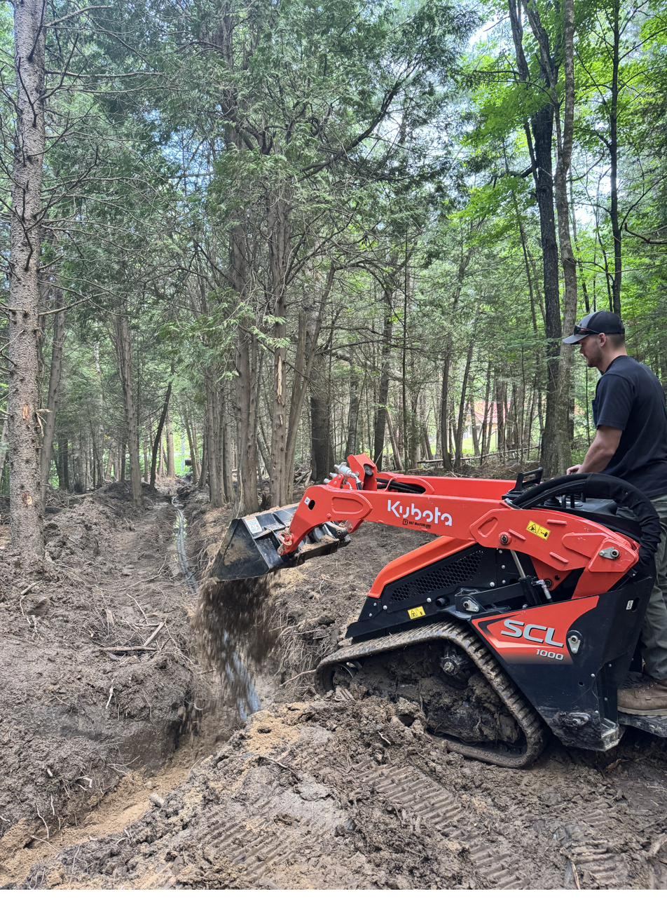 Trenching underground electrical service to a detached garage near Ottawa using a mini track loader